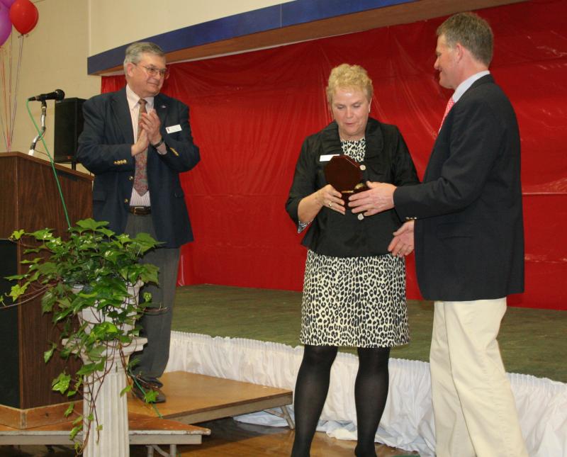 Peggy Pinkham, outgoing Y board president receives a gift from Y Executive Director Andy Hamblett. At left is incoming Y board president Wells Moore. KEVIN BURNHAM/Boothbay Register Pinkham