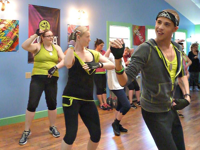 Sarah Gudroe, middle, does Zumba moves during the grand opening of her new studio at 951 Wiscasset Road in Boothbay. Her business partner Shane Hatcher dances in front of her, while her student-turned-instructor Kristen Campbell dances behind. KATRINA CLARK/Boothbay Register