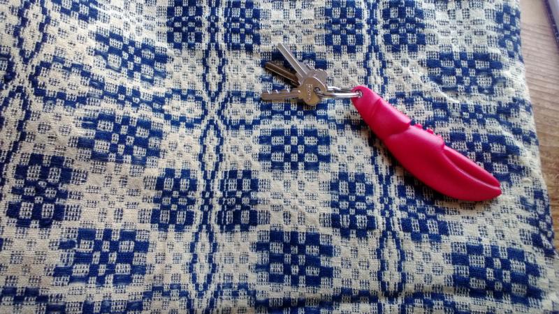An overshot coverlet on loan to the Lincoln County Historical Association from the Ulrich-Plunkett collection. The claw key chain is provided for scale. CASEY HOUSER/Boothbay Register