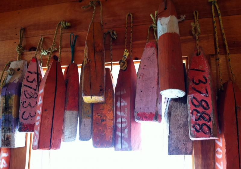 OLD WOOD BUOYS adorn walls and posts at the new shop in town, Nauticalia. SUZI THAYER/Boothbay Register