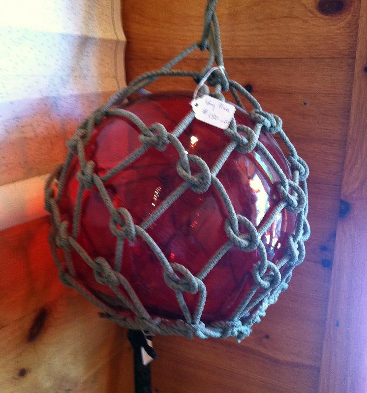 A RARE RED HUED FLOATING BALL hangs amid lots of the green/blue hued ones. SUZI THAYER/Boothbay Register