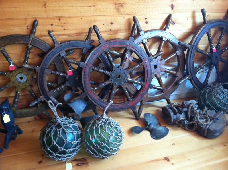SHIPS’ WHEELS, or helms, are scattered throughout the new shop, Nauticalia. SUZI THAYER/Boothbay Register