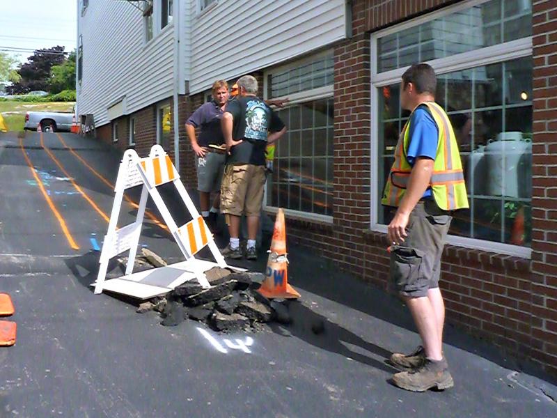The alleyway between Coastal Maine Popcorn and A Silver Lining is marked with chalk and hazard signs as the Public Works crew figures out where the damage is. KATRINA CLARK/Boothbay Register