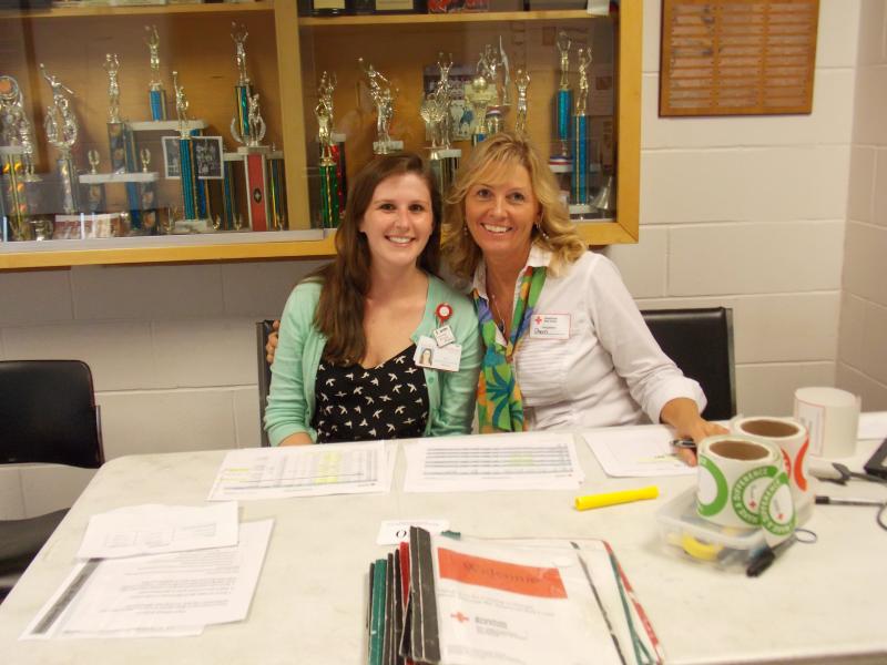 Volunteers Liz McIlwain, left, and Sheri Jones, right, man the registration table. KATRINA CLARK/Boothbay Register