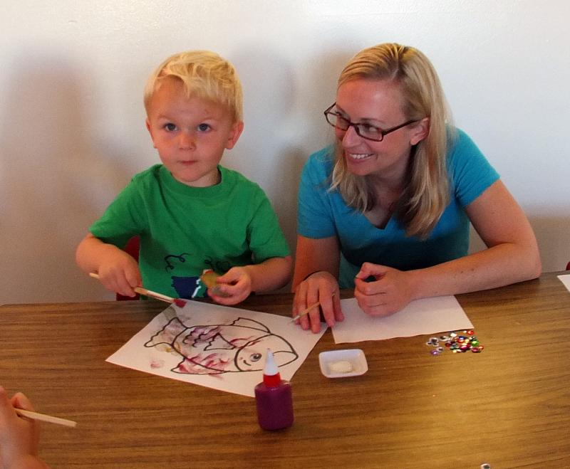 BEN HODGDON paints while his mom, Sarah looks on. SUZI THAYER/Boothbay Register