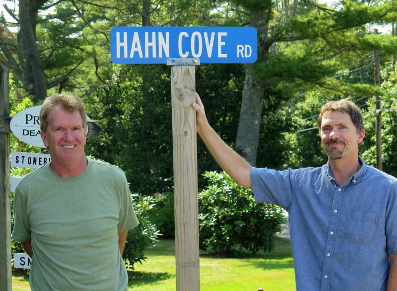 Robert, left, and Mike Hahn, visiting Maine from California for the first time, stand next to the McKown Point road sign honoring their ancestors. Courtesy of Stephen Rubicam