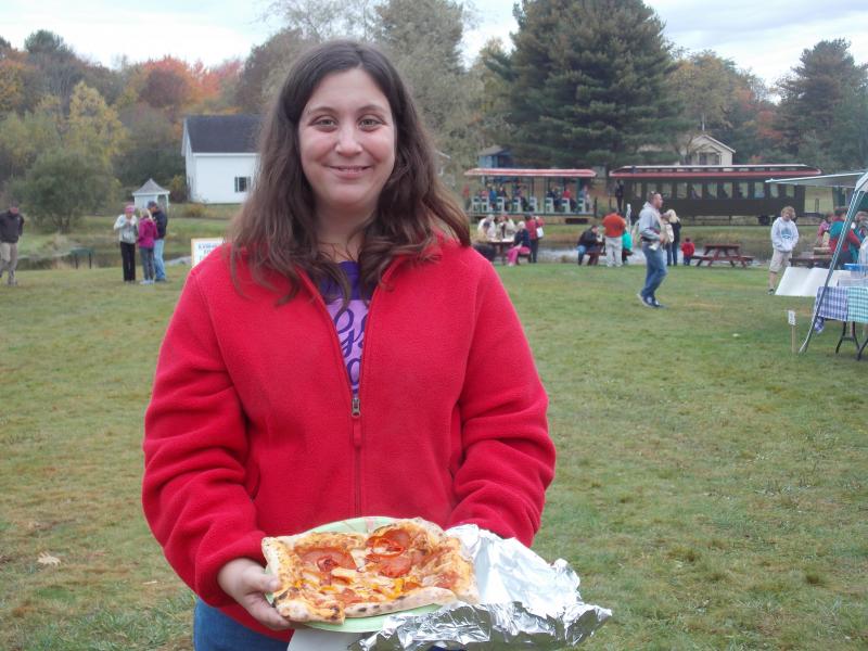 Jamie Sprague of Wiscasset ordered a pizza from the Crust pizza tent at the Fall Foliage Fair. KATRINA CLARK/Boothbay Register