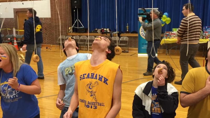 Matthew Burnham fights to the finish in the donut-on-a-string contest. KATRINA CLARK/Boothbay Register