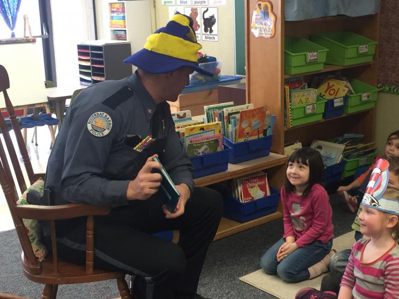 Chief Bob Hasch listens to Cali Brown talk about how much she likes “The Cat in the Hat.” KATRINA CLARK/Boothbay Register
