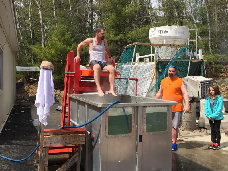 David Steinmetz, left over the dunk tank, and Chris Morton, right in the orange shirt, keep a close eye on Mara Gentry who likes to dunk them as often as possible. KATRINA CLARK/Boothbay Register