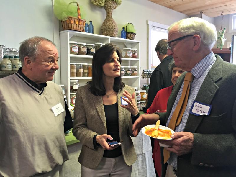 Russell Brackett and Leisha MacDougall of Harbor-Tech talk with Lincoln County Commissioner Ham Meserve about the pros and cons of different phone models. KATRINA CLARK/Boothbay Register