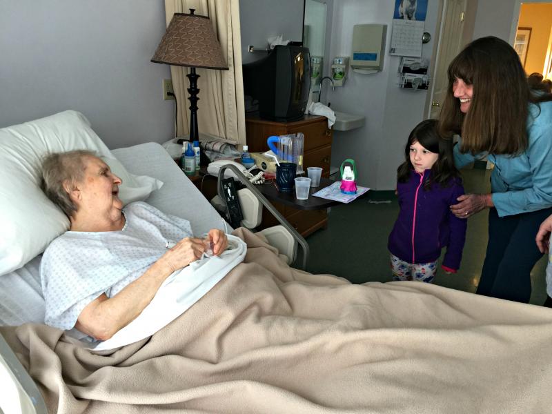 Resident May Hull accepts a basket from a shy Ava McDuff as Jeri Phinney introduces them. KATRINA CLARK/Boothbay Register