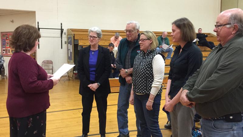 Town Clerk Michelle Farnham, far left, swears in newly elected and reelected representatives for Boothbay Harbor who were present at town meeting. From left after Farnham: Selectman Wendy Wolf, Cemetery District Trustee John Arsenault, CSD School Committee member Stephanie Hawke, Selectman Tricia Warren and Sewer District Trustee James Stormont. KATRINA CLARK/Boothbay Register