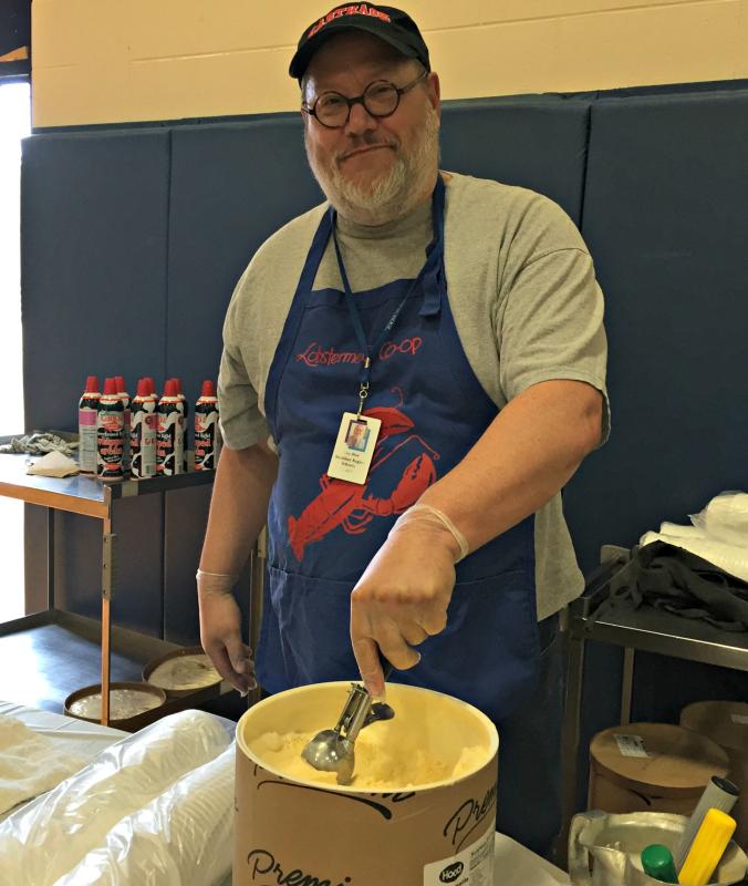 Principal Mark Tess scoops out vanilla ice cream during the ice cream social. KATRINA CLARK/Boothbay Register