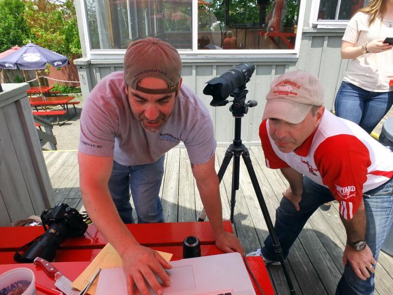 Photographer Ted Axelrod, left, and Lobster Dock owner Mitch Weiss confer about photos for the restaurant’s newly redesigned website. SUZI THAYER/Boothbay Register