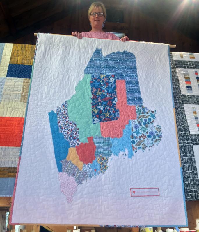 Molly Hutchins displays a quilt that she collaborated on with Deb Boucher. SUZI THAYER/Boothbay Register