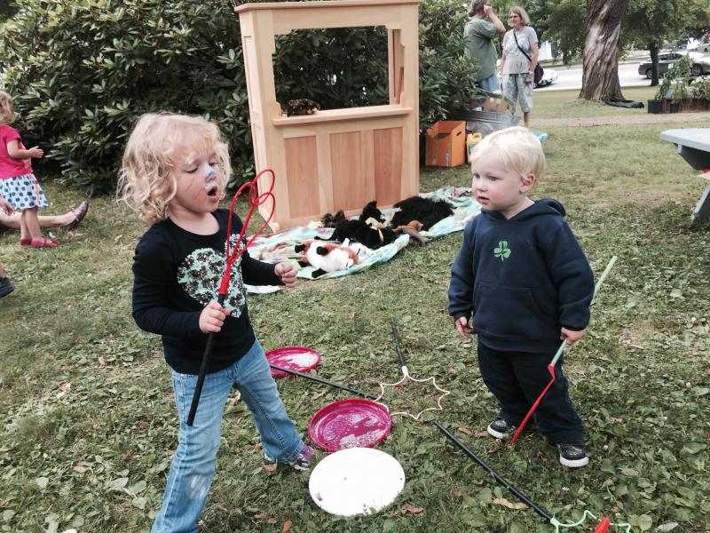Grace Daley, 3, and brother Charlie Daley, 2, of Hingham, Massachusetts, enjoy making bubbles at Summerfest on the Wiscasset common on July 26. SUSAN JOHNS/Wiscasset Newspaper