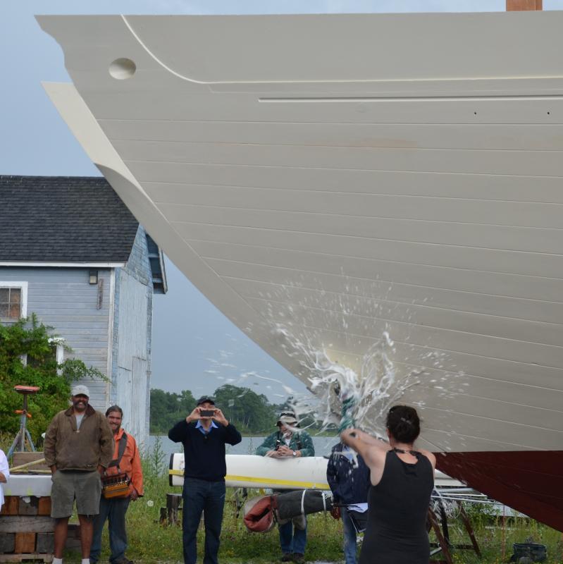 Jane Barnes breaks a bottle of champagne against the hull. (Photo by Lynda Clancy)