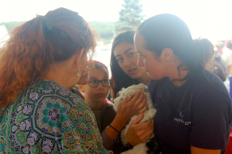 Nancy and Sara clip the nails of a small dog. ART MAYERS/Boothbay Register