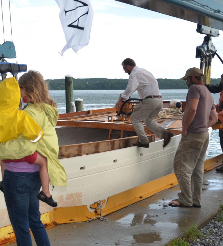 Capt. Noah Barnes climbs aboard the Ladona as she eases closer to the water. (Photo by Lynda Clancy)