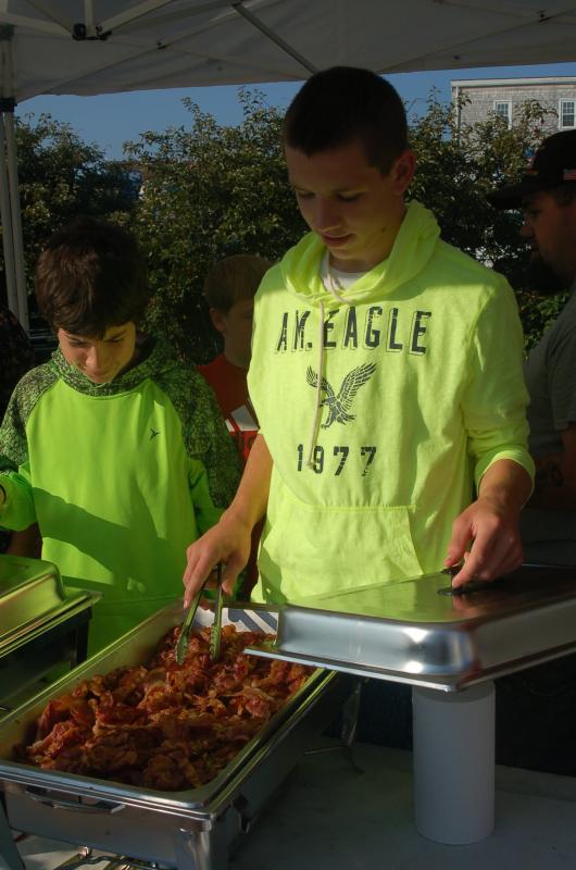 Hunter Crocker serves bacon. ART MAYERS/Boothbay Register