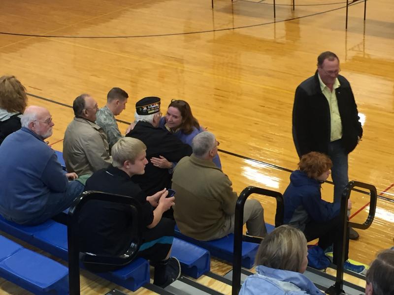 Superintendent Eileen King embraces veteran Palmer Payne before the ceremony. KATRINA CLARK/Boothbay Register
