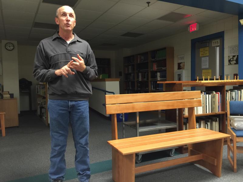 School Resource Officer Larry Brown presents the “Seahawk Bench” made from the former bleacher boards in the Porter Memorial Gymnasium to the Community School District Trustees Dec. 2. KATRINA CLARK/Boothbay Register