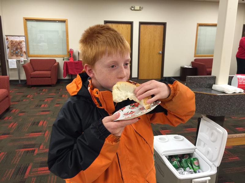 Slade Balsdon, 9, enjoys one of the freshly-grilled hot dogs served at the Business After Hours. KATRINA CLARK/Boothbay Register