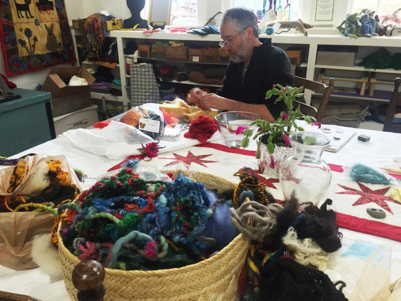 Tom Blackford works on Christmas tree decorations in preparation for the open house on Dec. 10. SUZI THAYER/Boothbay Register