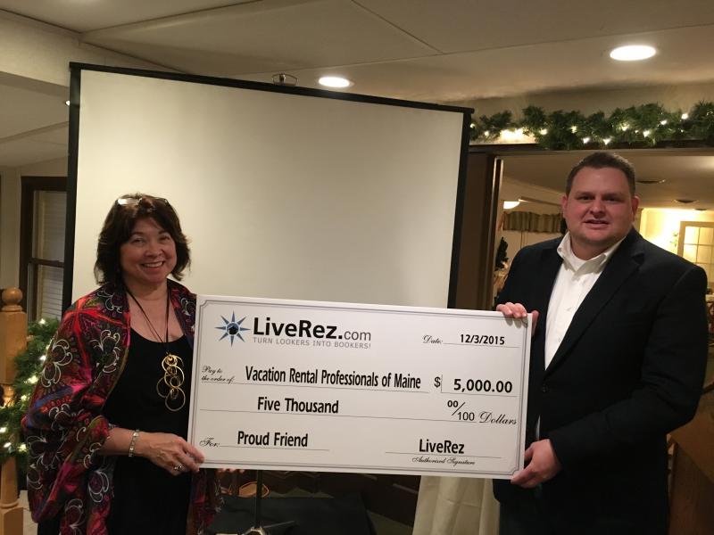 At its first meeting in Augusta on Dec. 3, VRPOMe (Vacation Rental Professionals of Maine) President Audrey L. Miller is presented with a check for $5000 by Tyler Hurst, vice president of marketing for LiveRez Software (Boise, Idaho). LiveRez owner Tracy Lotz said, “We want to support and affirm the successful and continuing efforts of this new Maine group in dealing with legislative and regulatory issues affecting vacation rentals in Maine, especially during the past three years.” There were 65 people in attendance representing over 31 Maine vacation rental businesses. Courtesy photo