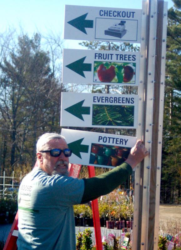 “Uncle” Roy Lupien posts directional signs to the 19 greenhouses. ART MAYERS/Boothbay Register