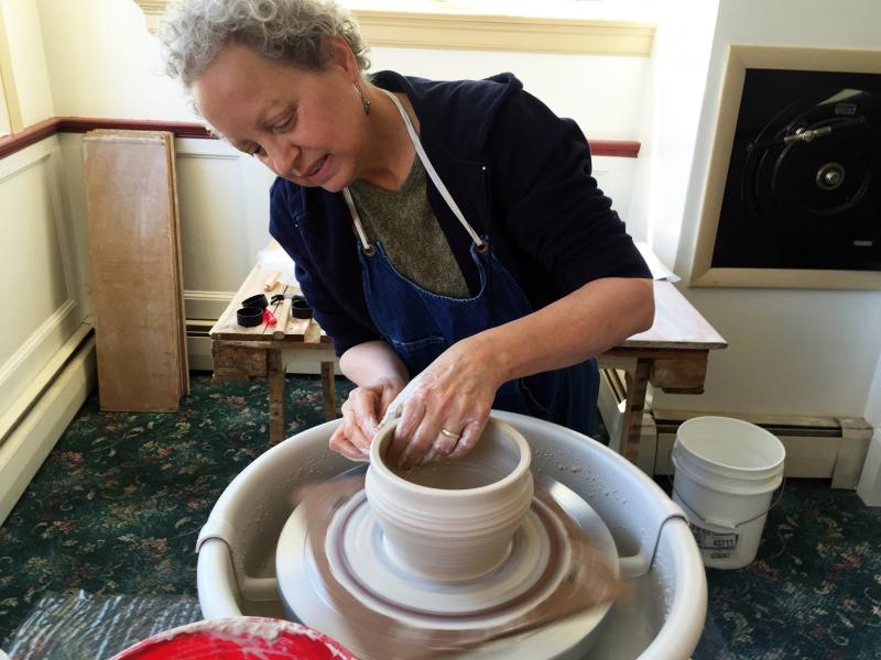 Julie Moore gets her hands dirty throwing a pot in her new shop in Boothbay Harbor, Dirty Bird Pottery. SUZI THAYER/Boothbay Register