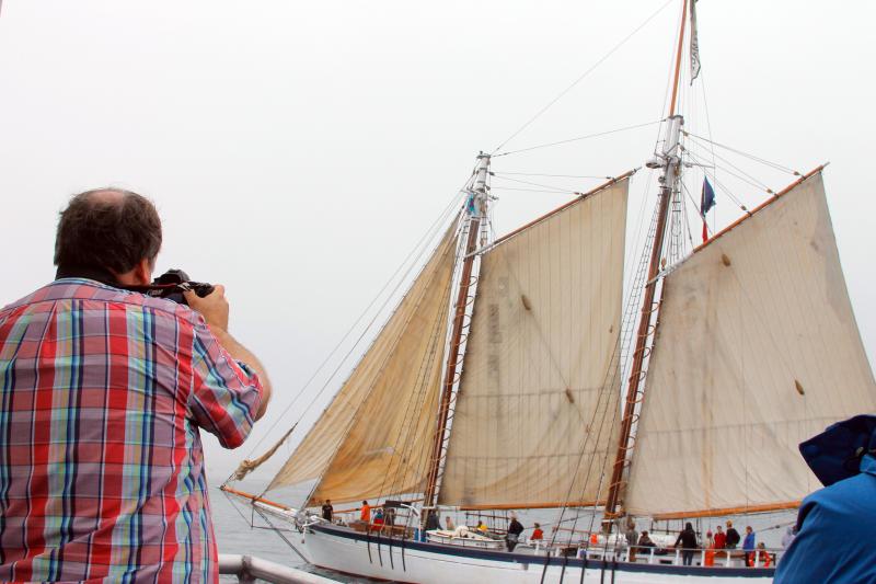 Micheal Leonard takes a shot of a Windjammer as it makes its way into Boothbay Harbor on June 29. SUZI THAYER/Boothbay Register