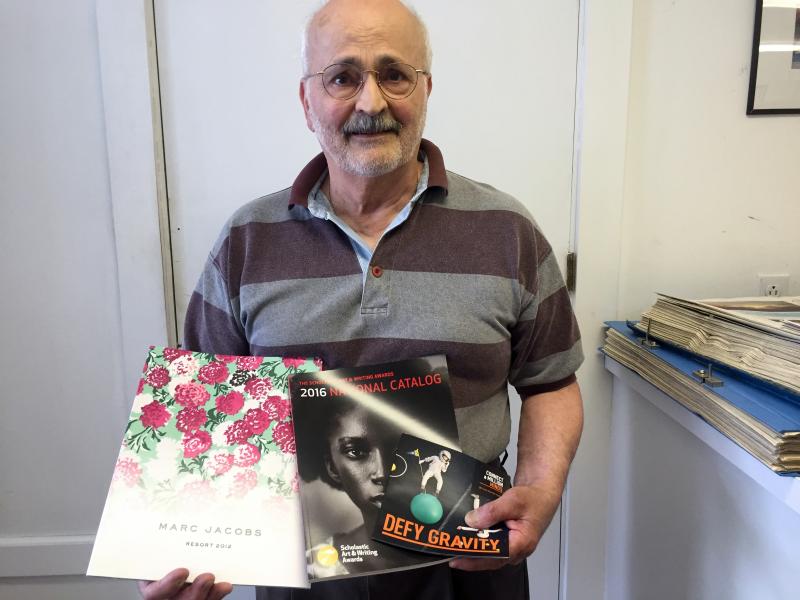 Jimmy Hanna, of Prints Charming Printers, wants people to know he’s not reitred. Here he holds some of the work he has done for Marc Jacobs, Scholastic and Time Warner Cable. SUZI THAYER/Boothbay Register