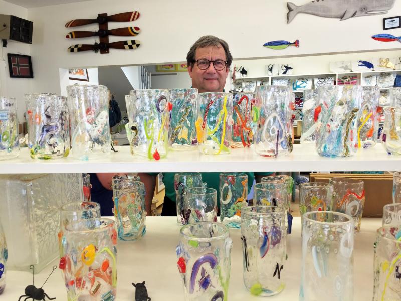 Ken Rayle stands behind a display of Tandem glassware in Sweet Bay. SUZI THAYER/Boothbay Register
