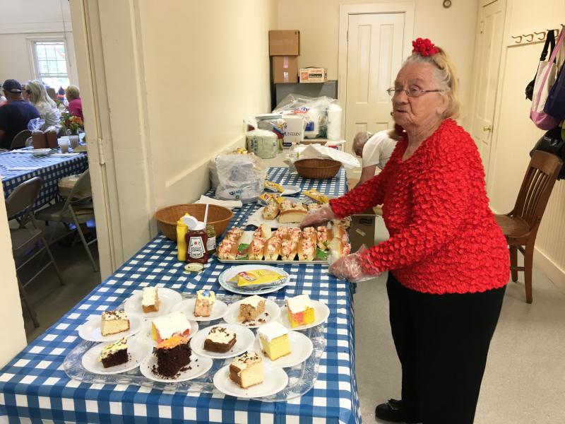 Ramona Gaudette serves up lobster rolls at the Southport Country Fair and Lobster Roll Luncheon on July 20. SUZI THAYER/Boothbay Register