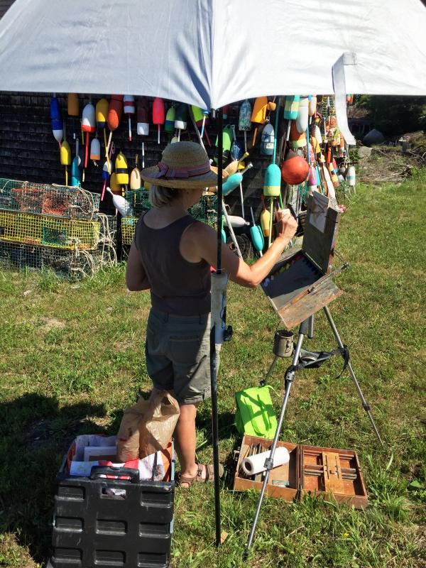 Roberta Goschke, of Waldoboro, chose to paint near a boathouse across the road from Knickercane Island on July 13. SUZI THAYER/Boothbay Register
