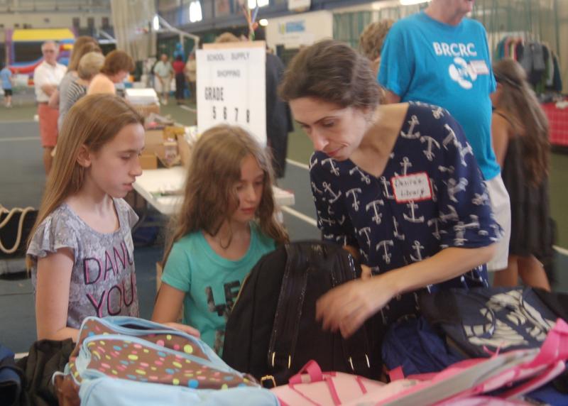 Amina and Maggie Halter get help picking out backpacks. ART MAYERS/Boothbay Register