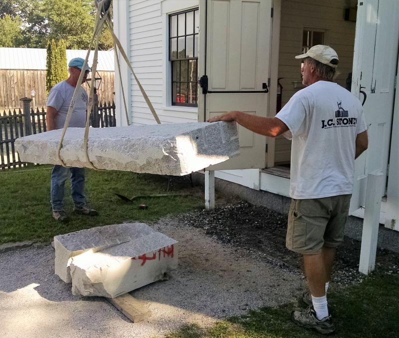 Getting the first step into position Aug. 25 at the 1847 Town Hall at the Boothbay Railway Village Musuem. Installation of new granite steps at Boothbay Railway Village Town Hall Boothbay ME
