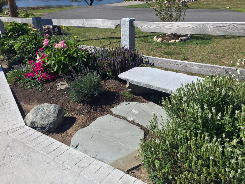 A stone bench, donated by someone in memory of his wife, at the east end of the footbridge. SUZI THAYER/Boothbay Register
