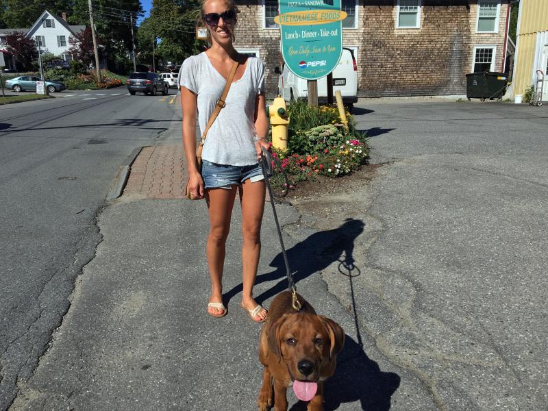 Melissa Matthews, who is working as a bartender at Ports of Italy for the summer, with her dog Rusty. They’re not from away, but they were cute enough to snap a photo of. SUZI THAYER/Boothbay Register