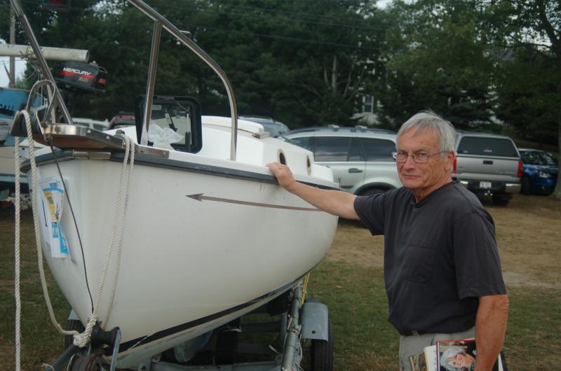 Bob Gill eyes a sailboat donated for the live auction. ART MAYERS/Boothbay Register