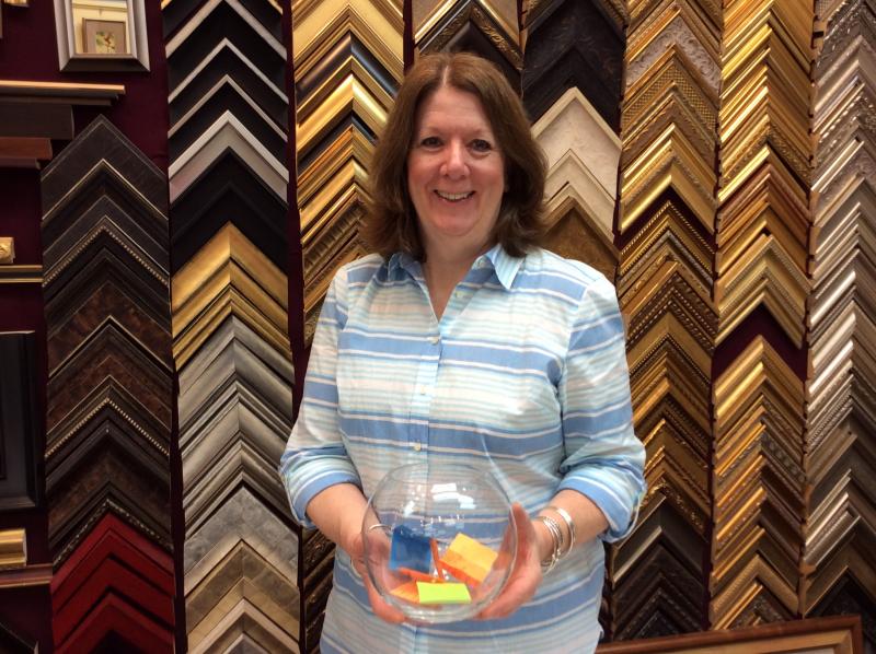 Susan Brackett of Boothbay Harbor Framers holds a fishbowl with Monday’s “Jeopardy” guesses. Will one of those names win the grand prize on Sept. 10? KATRINA RICKERMANN/Boothbay Register