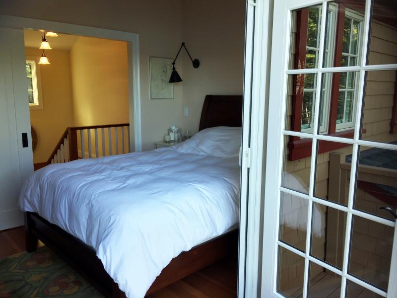 The master bedroom has French doors that open to a deck overlooking the water. SUZI THAYER/Boothbay Register