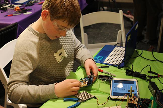 Russell Webster of Wiscasset wires up the interface between a microcontroller and a self-driving robot during Gizmo Garden at Skidompha Library last February. Courtesy photo