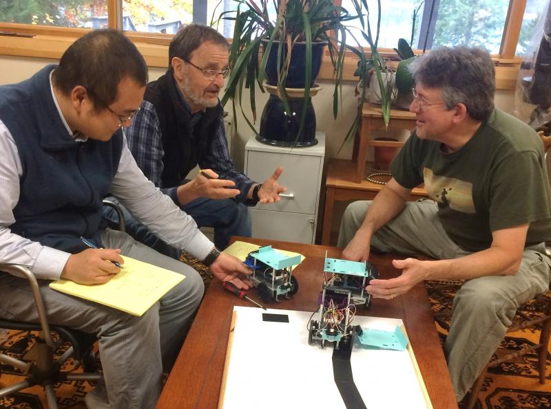 Post-Doctoral researcher Liang Wang and Professor Berthold Horn of MIT discuss with Bill Silver having Gizmo Garden students build self-driving robots for use in traffic flow research. Courtesy photo