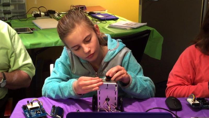 Arden Carleton of Edgecomb adds a tail wheel to a self-driving robot during Gizmo Garden at Skidompha Library last February. Courtesy photo