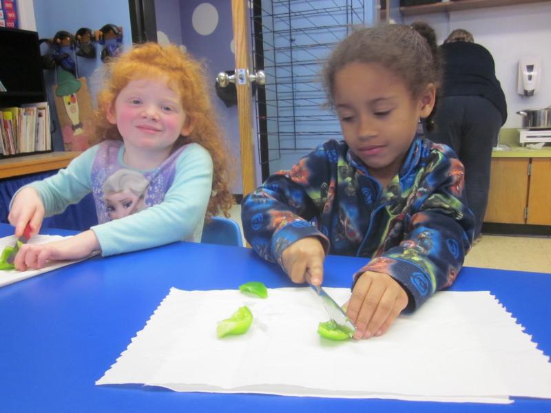 Beatrice and Xaviera, from Mrs. Spaulding’s Kindergarten class, are busy cutting up veggies for the feast! Courtesy of Lucy Ann Spaulding