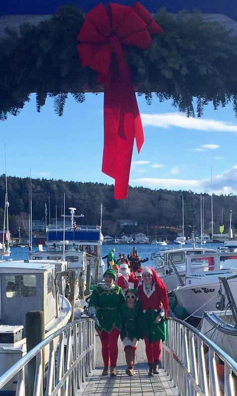 The Clauses’ North Pole entourage makes its way up the Town Landing ramp ... It must be Harbor Lights in Boothbay Harbor! LISA KRISTOFF/Boothbay Register