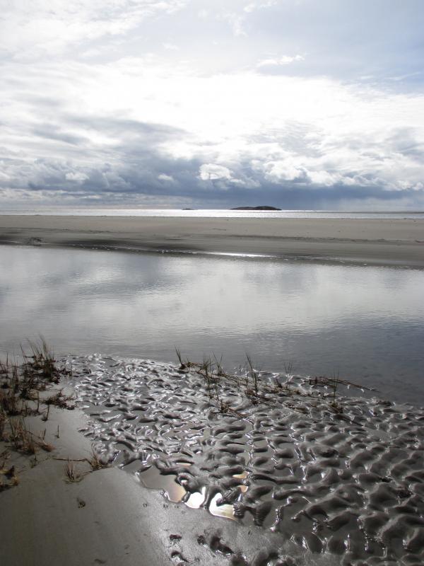 A Popham Beach tidal channel at low tide with the ocean beyond. PHIL DI VECE/Wiscasset Newspaper